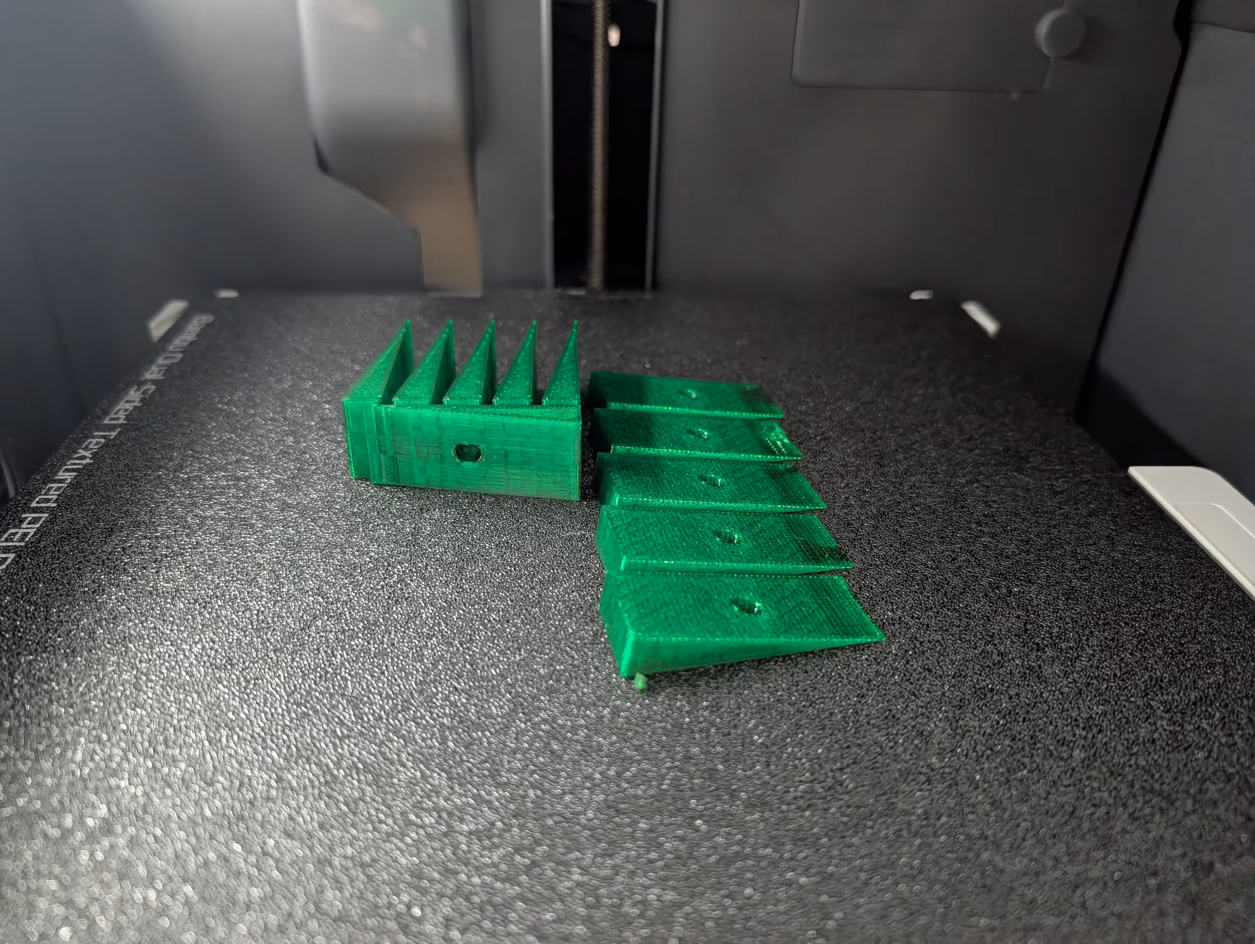3D-printed triangles on a 3D-printer print bed