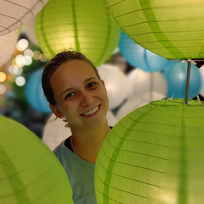 Smini peeking from behind lanterns