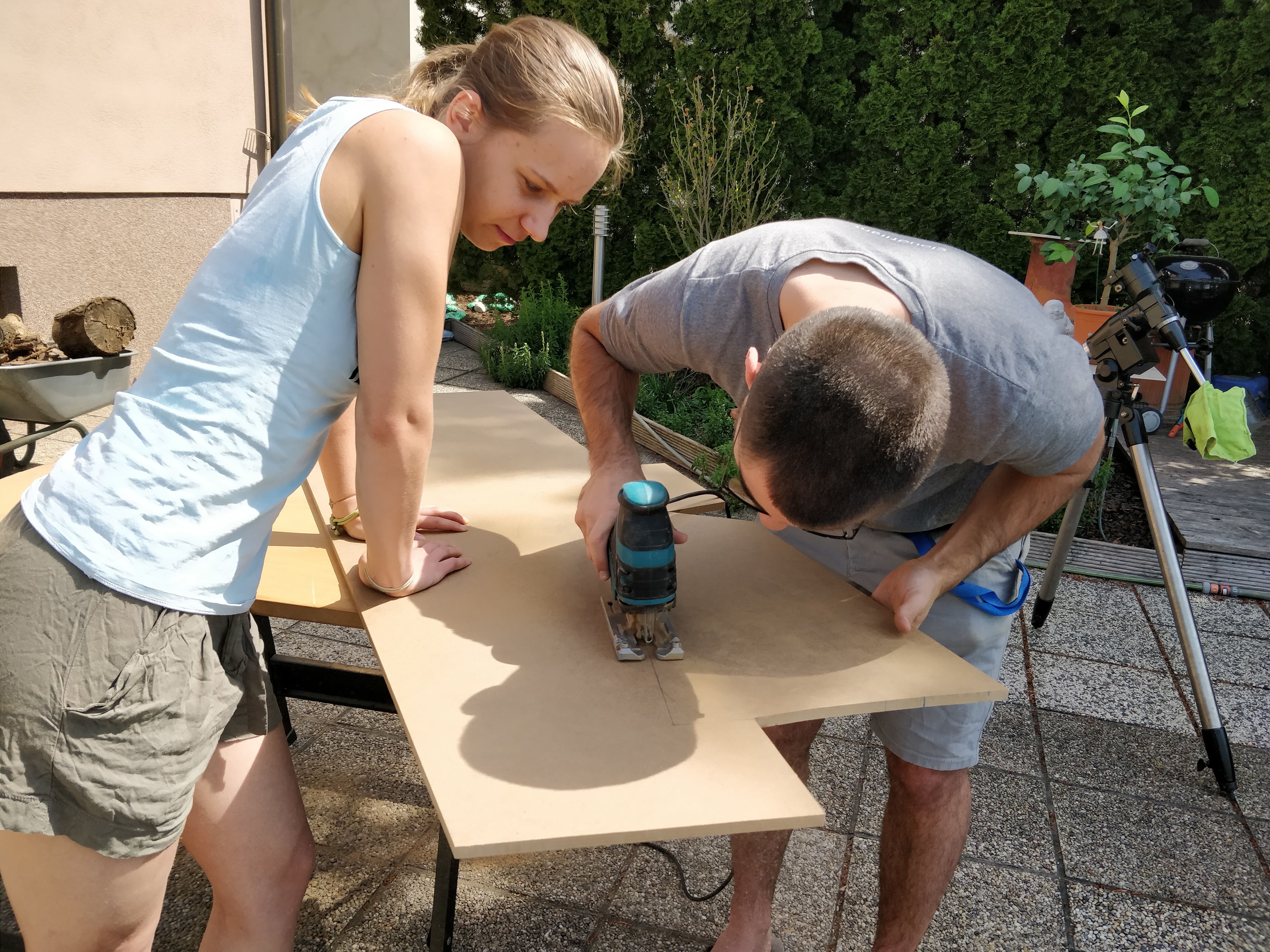 my husband and myself, cutting wooden panels